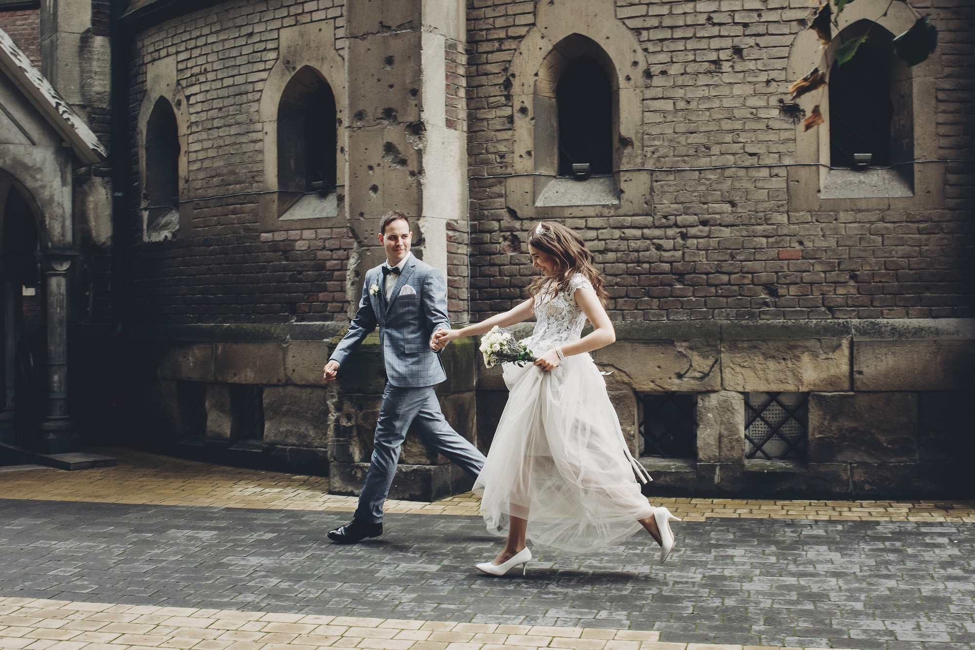 beautiful emotional wedding couple running and smiling in european city provence wedding.jpg
