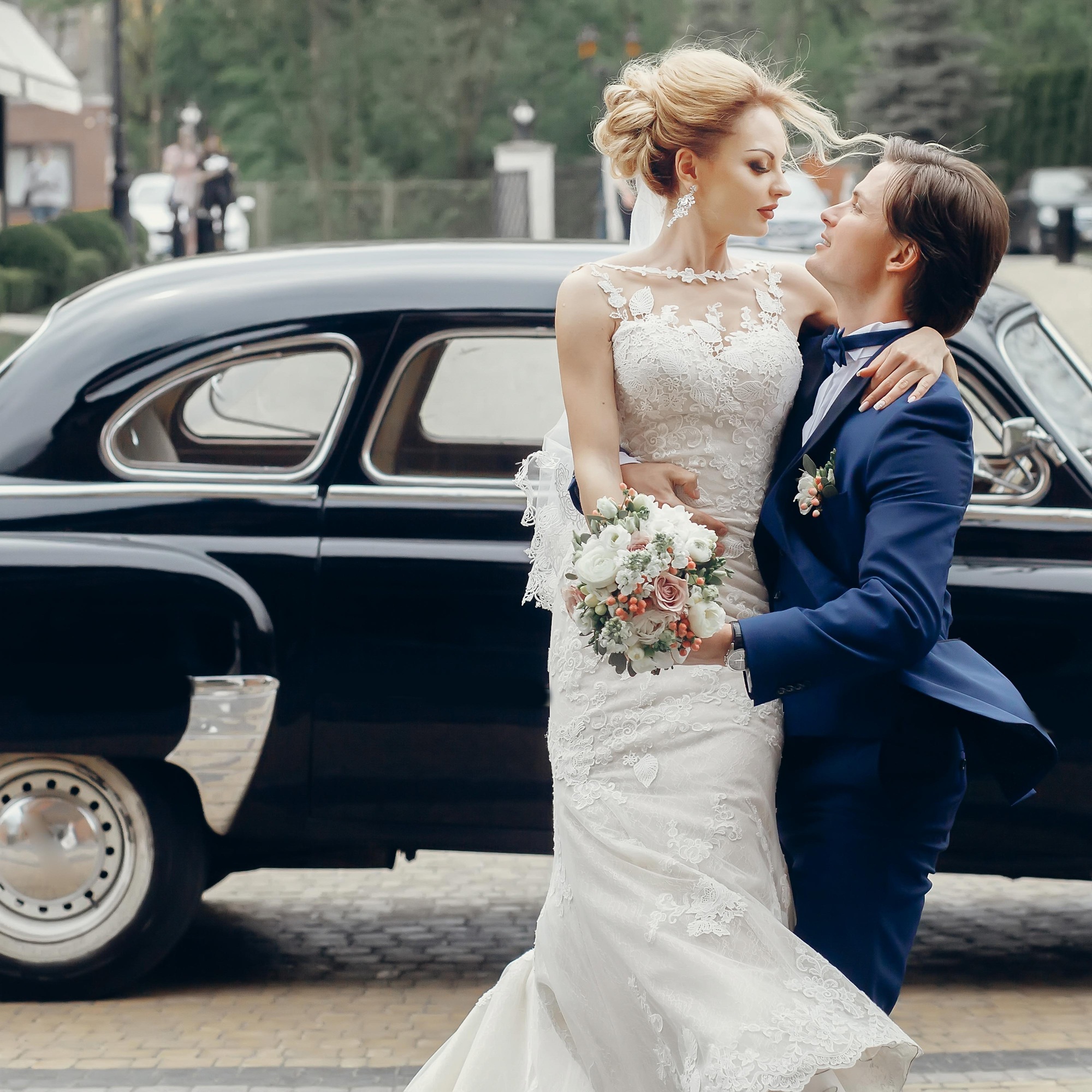 luxury wedding couple dancing at old car in light.jpg